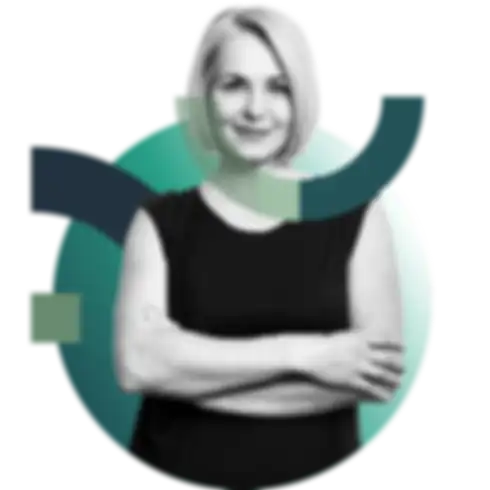 A smiling blonde woman with folded arms